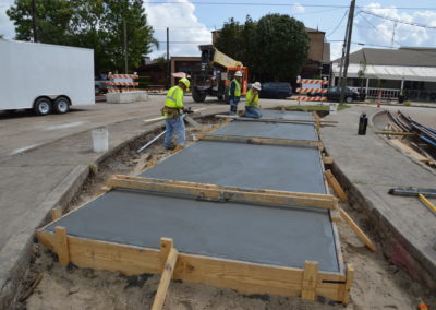 Boh Bros putting down concrete foundation on a road